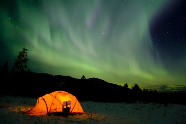 northern lights, aurora borealis, tent, snow shoes, Yukon Territory, Canada
